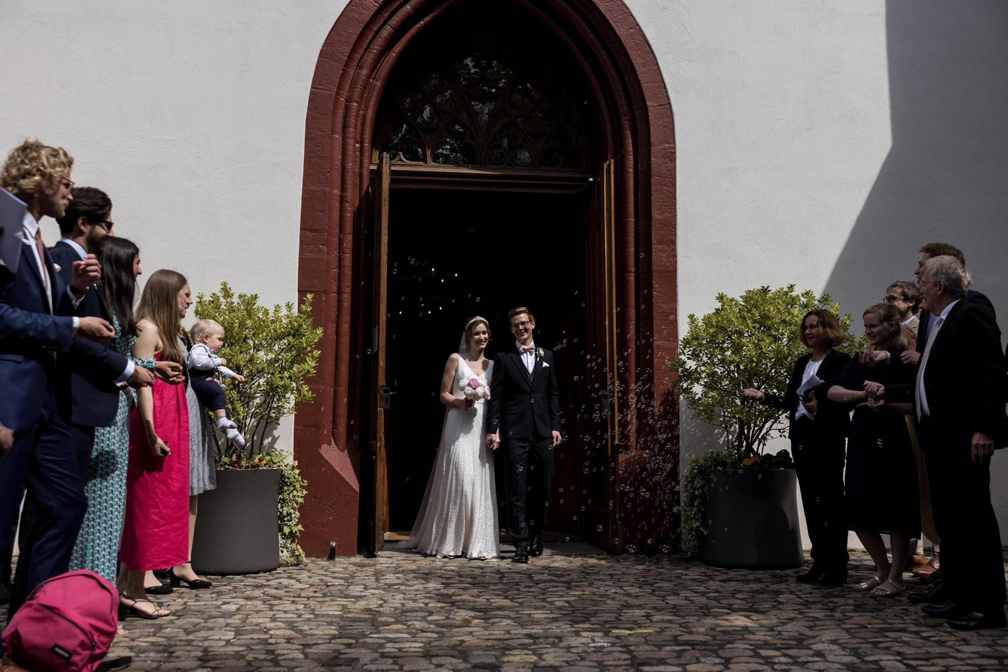 der Auszug aus der Kirche mit Spalier - Hochzeit in der Peterskirche in Basel - Hochzeitsfotografen Basel